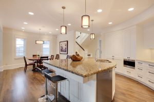 Calgary home renovation. White kitchen cabinets that run along a rounded wall.
