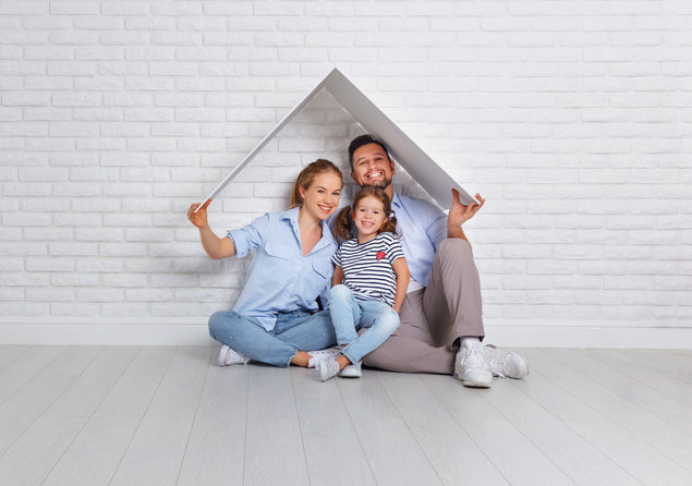 Calgary interior designer - family under cardboard roof in front of white background