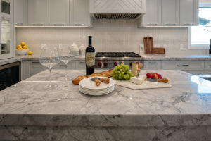 kitchen staging with fruit, cheese and wine