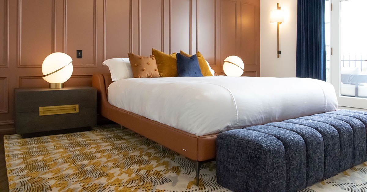 Furniture and Decor - Master Bedroom with brown leather luxury bed, a dressing bench, and globe lights nesting on exquisite side tables.