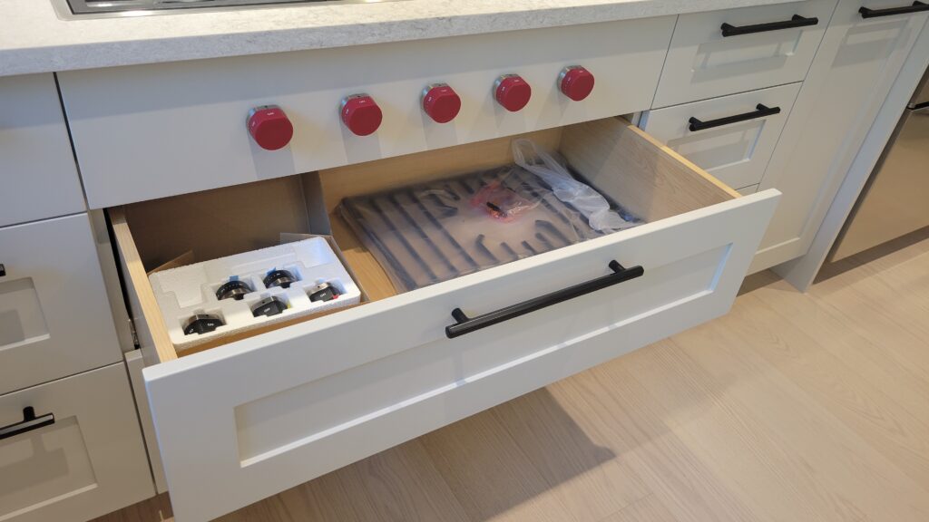 Kitchen layout - large drawer beneath stovetop gas range.