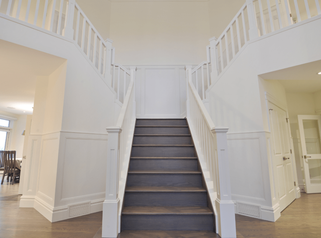 2023 Design Trends - #2 Architectural details - Grand split staircase with detailed trim