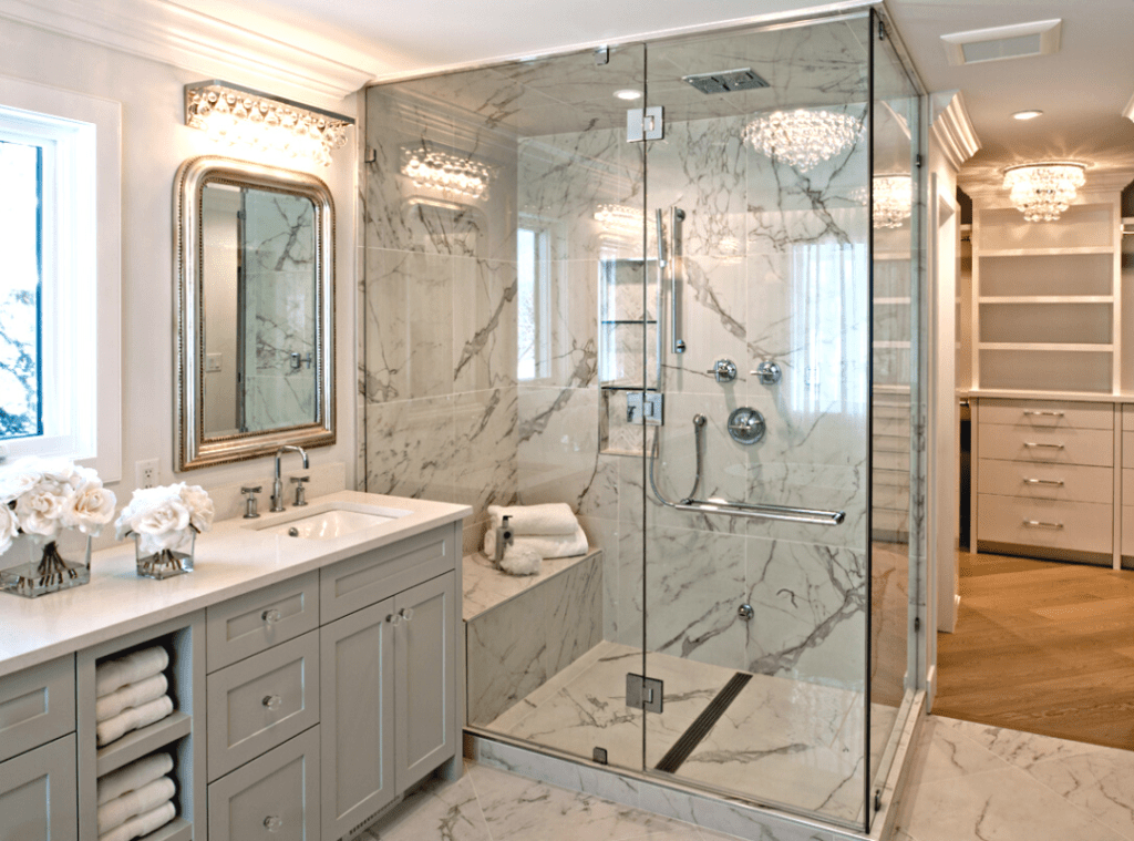 2023 Design Trends - #6 - Luxurious bathroom with dark veining on shower & floor tiles.